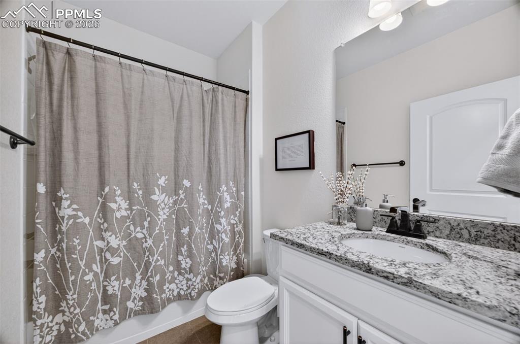 4658 Copeland Circle, Unit 103 Highlands Ranch, CO 80126 - Photo 20 of 37 a bathroom with a granite countertop sink and a mirror