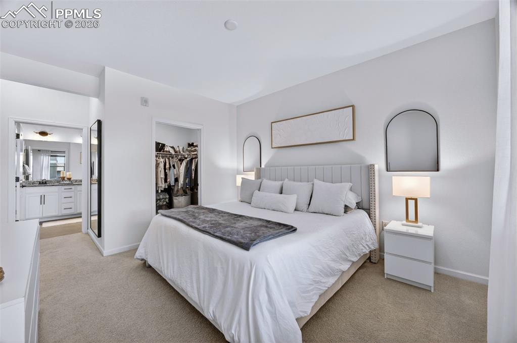 4658 Copeland Circle, Unit 103 Highlands Ranch, CO 80126 - Photo 23 of 37 a bedroom with bed and a night stand