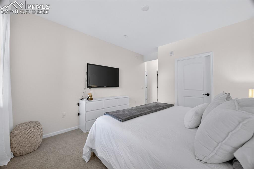 4658 Copeland Circle, Unit 103 Highlands Ranch, CO 80126 - Photo 25 of 37 a bedroom with a bed and a flat screen tv