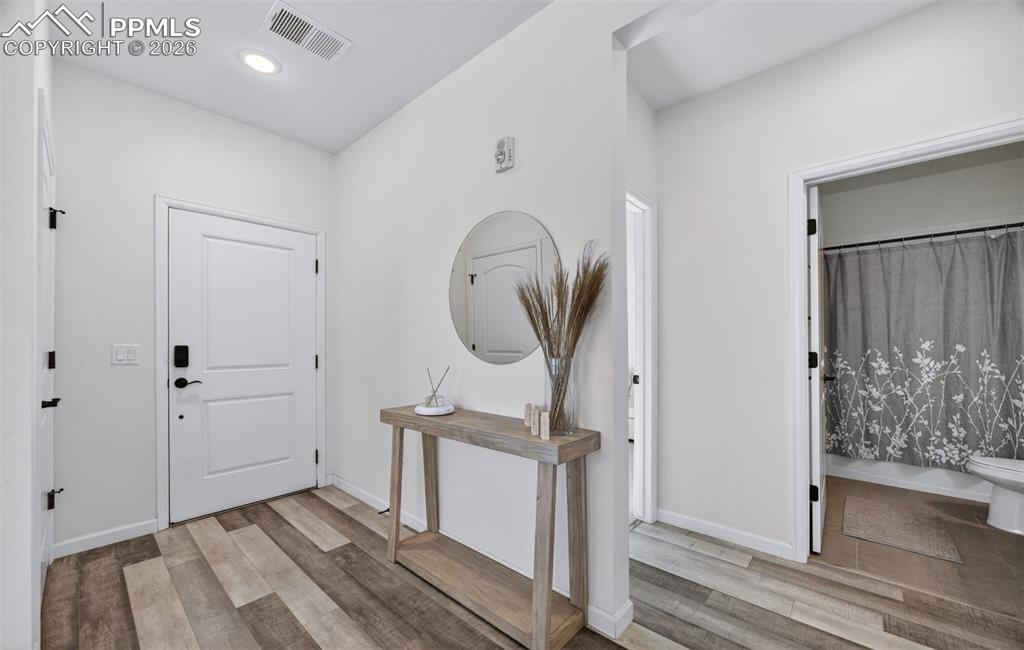 4658 Copeland Circle, Unit 103 Highlands Ranch, CO 80126 - Photo 7 of 37 a view of a hallway with wooden floor and staircase