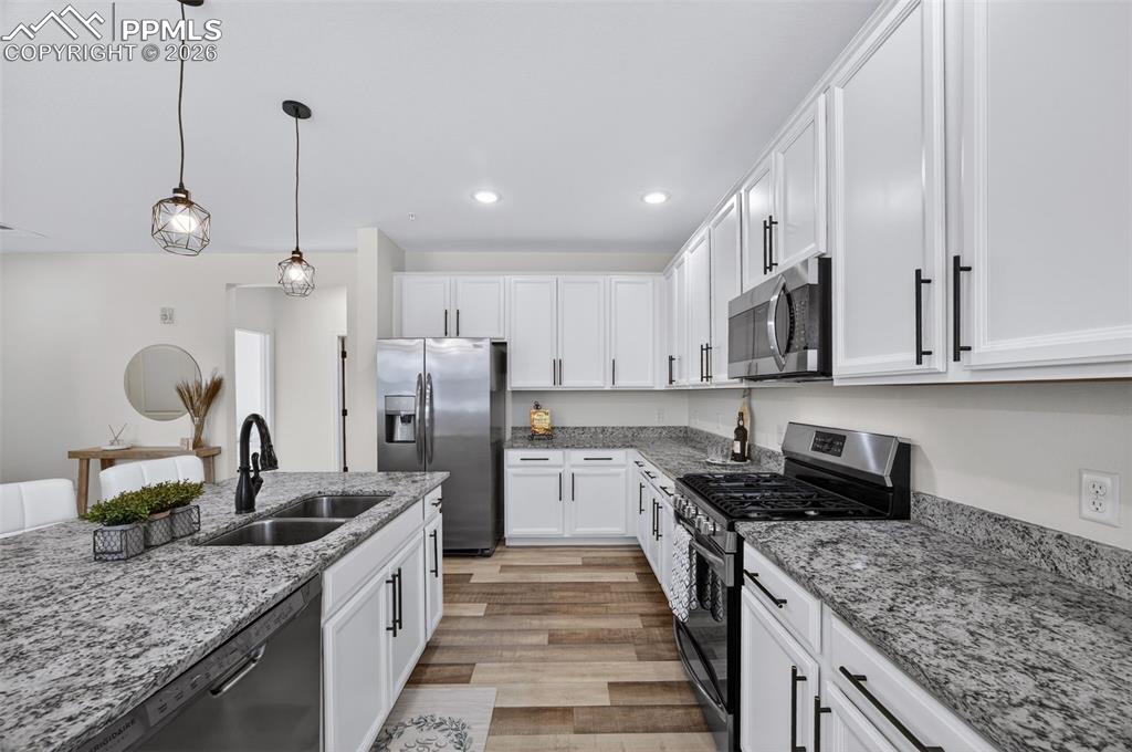 4658 Copeland Circle, Unit 103 Highlands Ranch, CO 80126 - Photo 8 of 37 a kitchen with stainless steel appliances granite countertop a sink stove and refrigerator