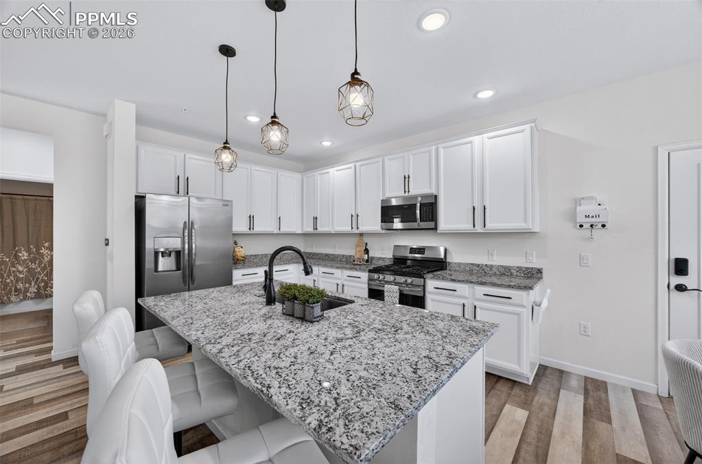 4658 Copeland Circle, Unit 103 Highlands Ranch, CO 80126 - Photo 9 of 37 a kitchen with stainless steel appliances granite countertop a sink stove and refrigerator