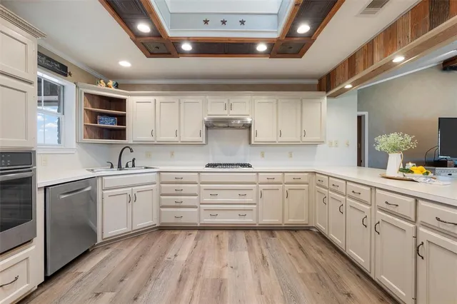 a kitchen with granite countertop white cabinets and white appliances