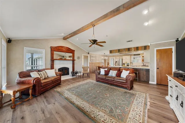 a living room with furniture a fireplace and a table