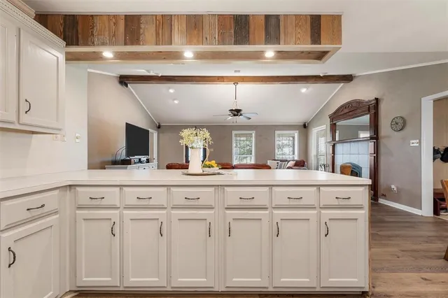a kitchen with granite countertop a sink and cabinets