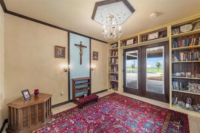 a living room with hard wood flooring and a book shelf