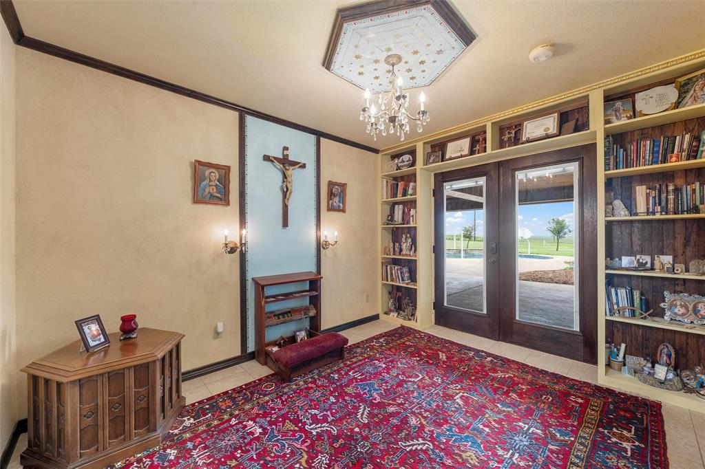 3057 Holy Road Abbott, TX 76621 - Photo 21 of 40 a living room with hard wood flooring and a book shelf