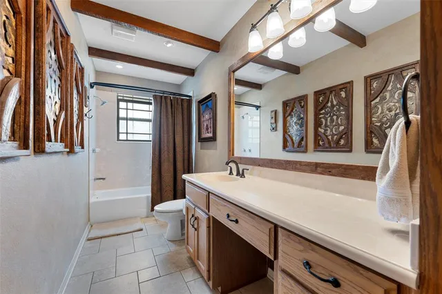 a bathroom with a sink a toilet a mirror and vanity