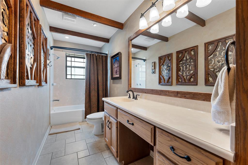 3057 Holy Road Abbott, TX 76621 - Photo 29 of 40 a bathroom with a sink a toilet a mirror and vanity