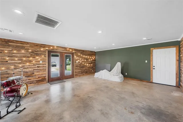 a large bedroom with a bed and gym equipment