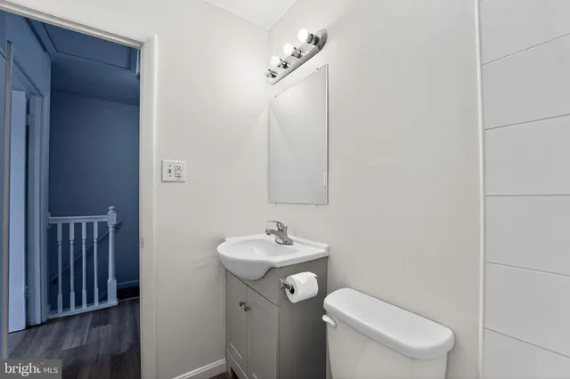 a bathroom with a toilet sink and mirror