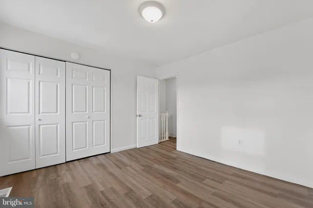 a view of an empty room and wooden floor