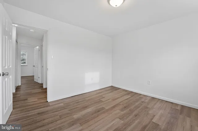 a view of a room with wooden floor