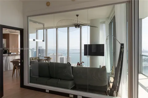 a living room with patio furniture and a flat screen tv
