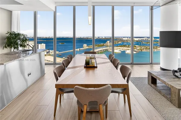 a view of a dining room with furniture large windows and wooden floor