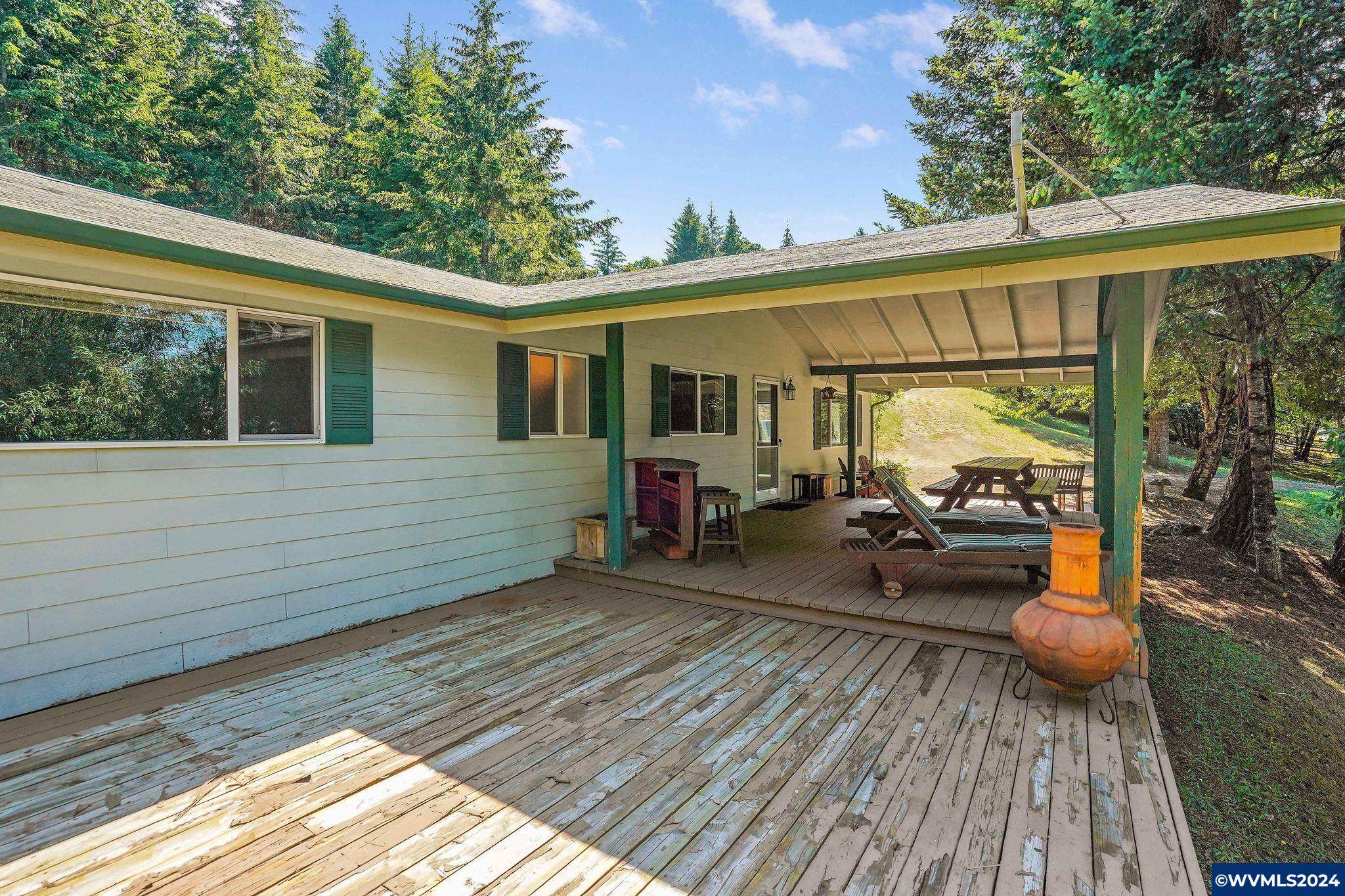 1787 Cochrane Lane Dallas, OR 97338 - Photo 4 of 42 a view of a house with wooden deck and furniture