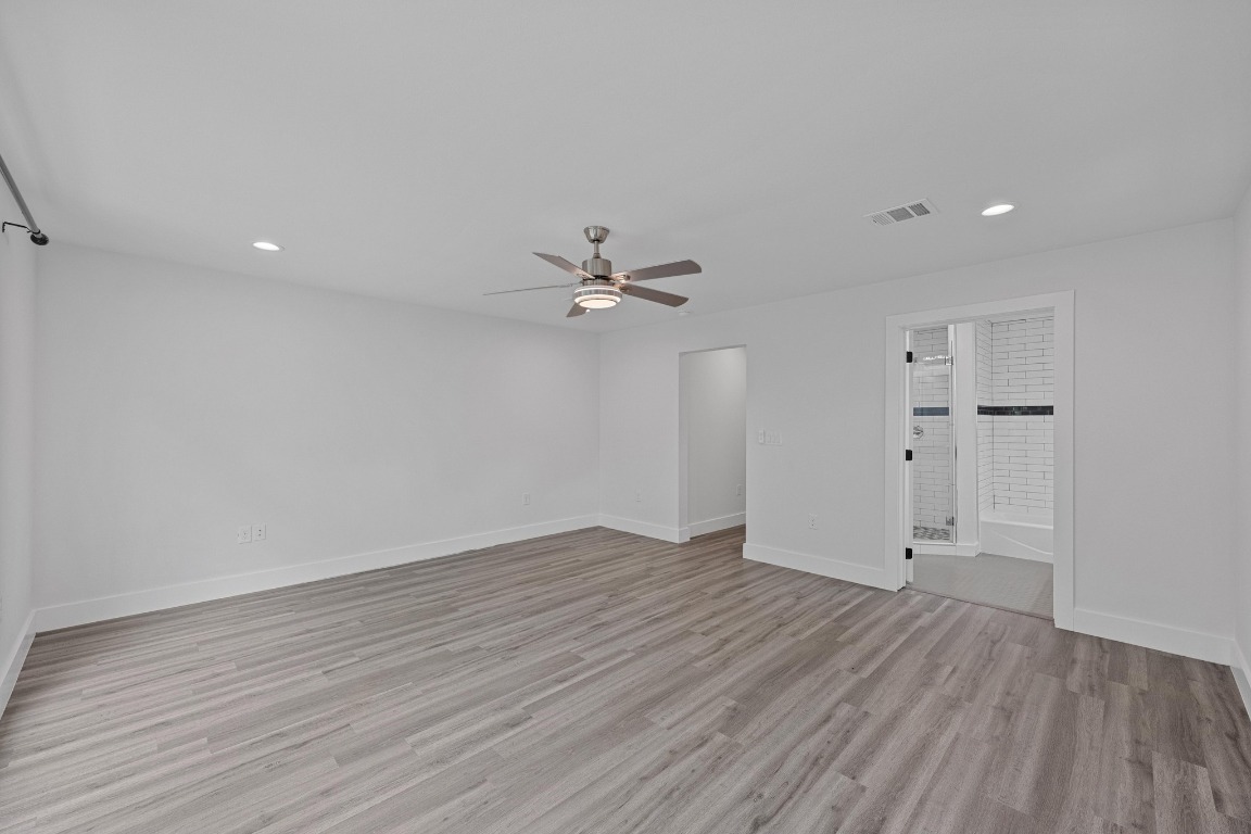 4705 Louis Avenue, Unit B Austin, TX 78721 - Photo 16 of 39 Empty room featuring a ceiling fan, light wood-style flooring, baseboards, visible vents, and recessed lighting