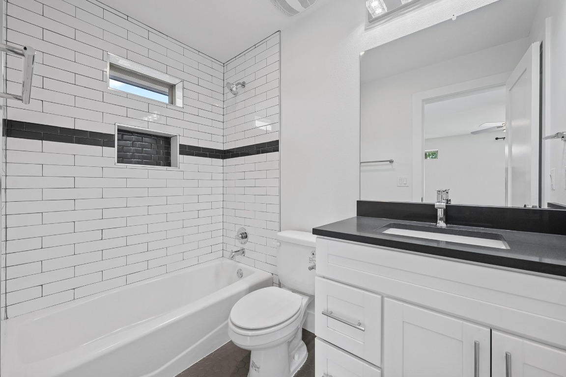 4705 Louis Avenue, Unit B Austin, TX 78721 - Photo 22 of 39 Full bathroom featuring tub / shower combination, vanity, and toilet