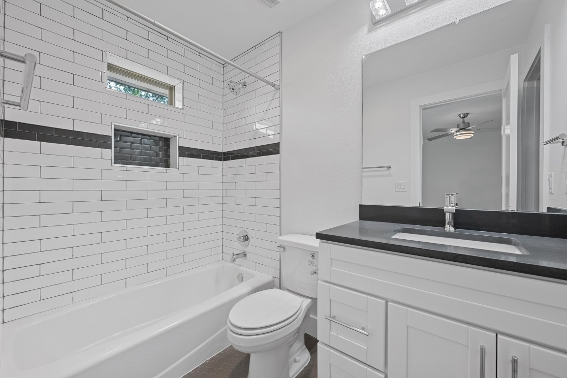 4705 Louis Avenue, Unit B Austin, TX 78721 - Photo 24 of 39 Bathroom featuring toilet, a ceiling fan, vanity, and bathing tub / shower combination
