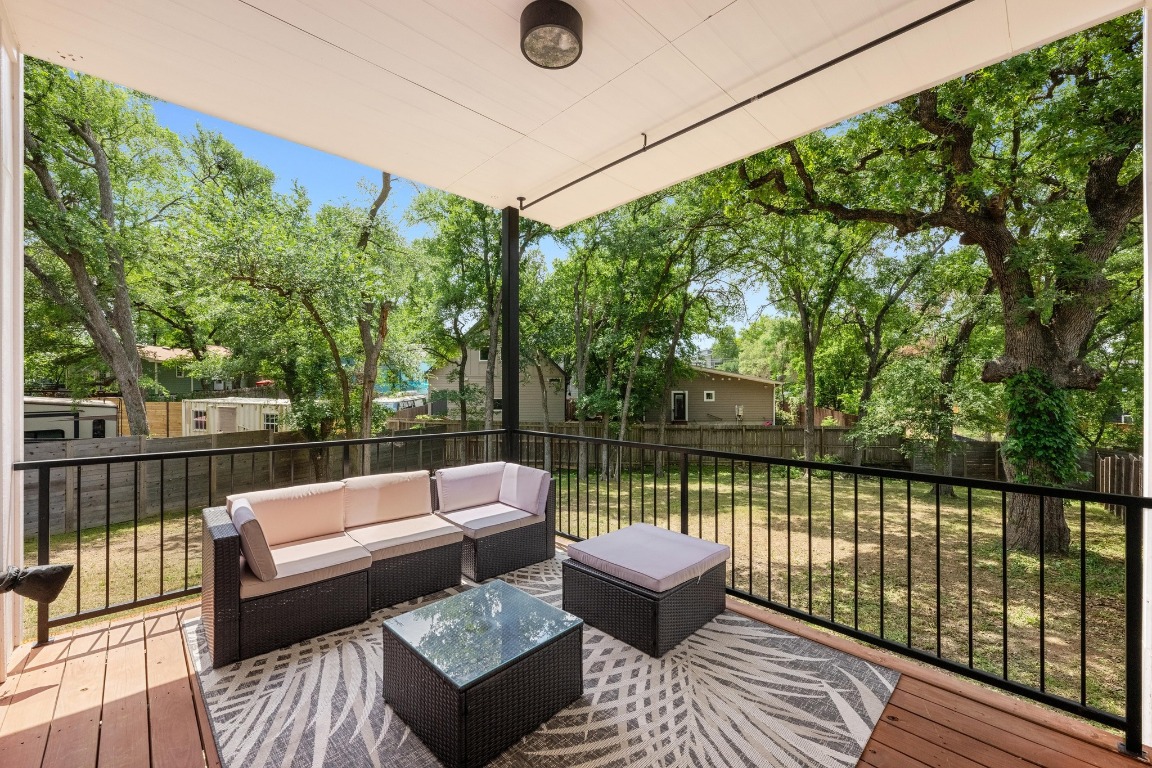 4705 Louis Avenue, Unit B Austin, TX 78721 - Photo 28 of 39 Wooden terrace featuring a fenced backyard, an outdoor living space, and a lawn
