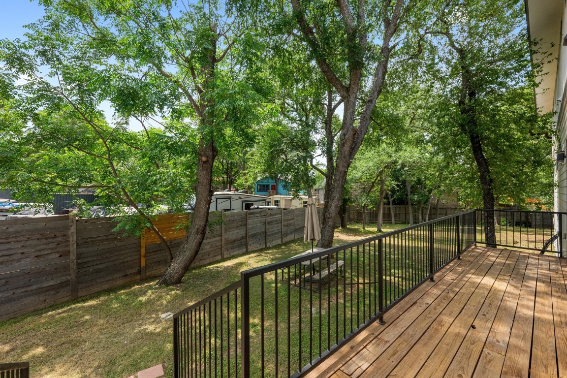 4705 Louis Avenue, Unit B Austin, TX 78721 - Photo 30 of 39 Wooden deck with a fenced backyard and a yard