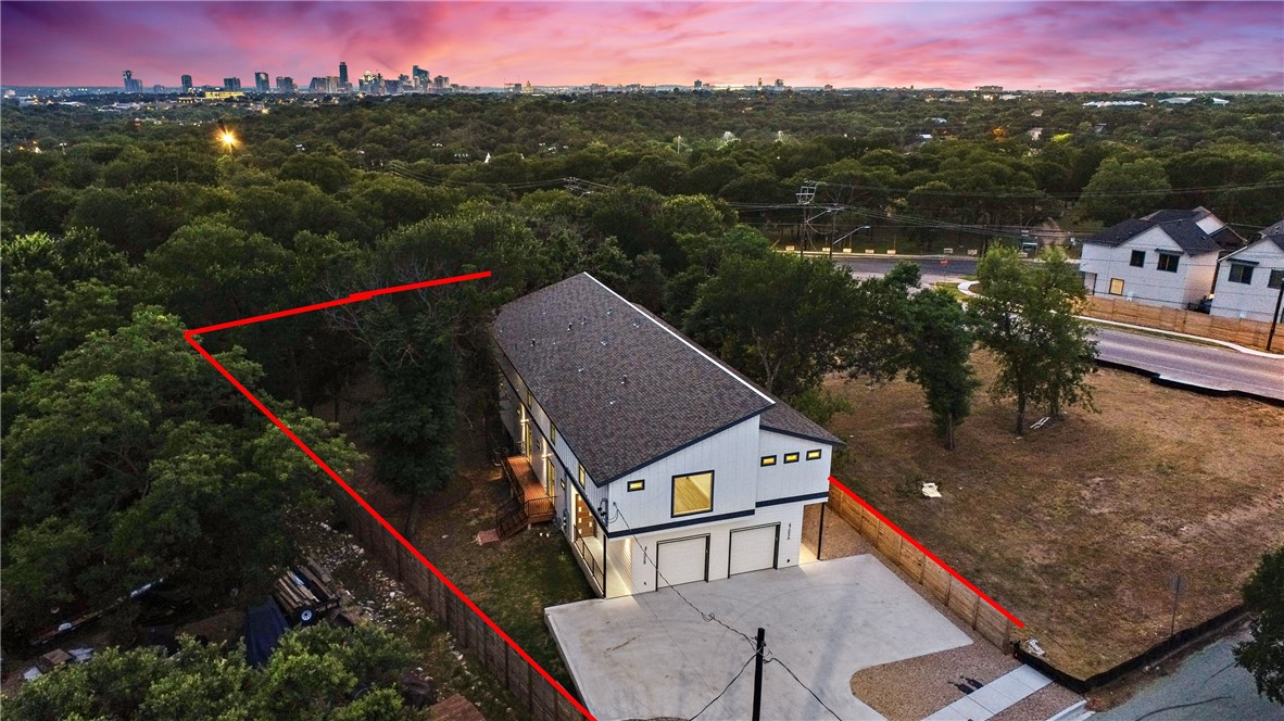 4705 Louis Avenue, Unit B Austin, TX 78721 - Photo 35 of 39 Aerial view at dusk featuring a wooded view