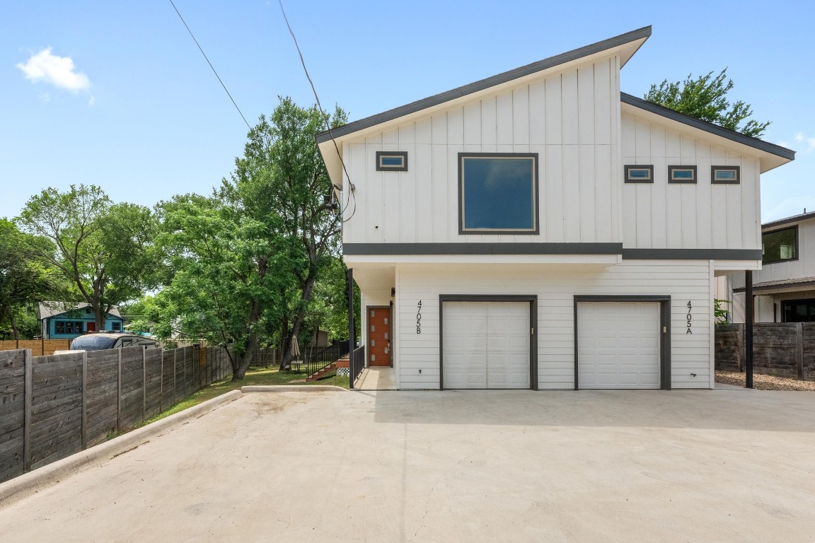 4705 Louis Avenue, Unit B Austin, TX 78721 - Photo 9 of 39 Modern farmhouse style home with concrete driveway, fence, board and batten siding, and a garage
