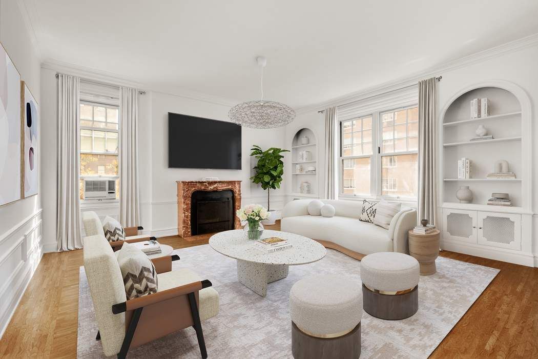 150 East 72nd Street, Unit 6S Manhattan, NY 10021 - Photo 1 of 23 a living room with furniture a fireplace and a flat screen tv