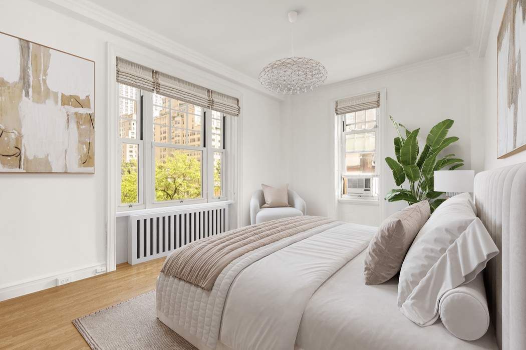 150 East 72nd Street, Unit 6S Manhattan, NY 10021 - Photo 10 of 23 a bedroom with a bed and a large window with wooden floor