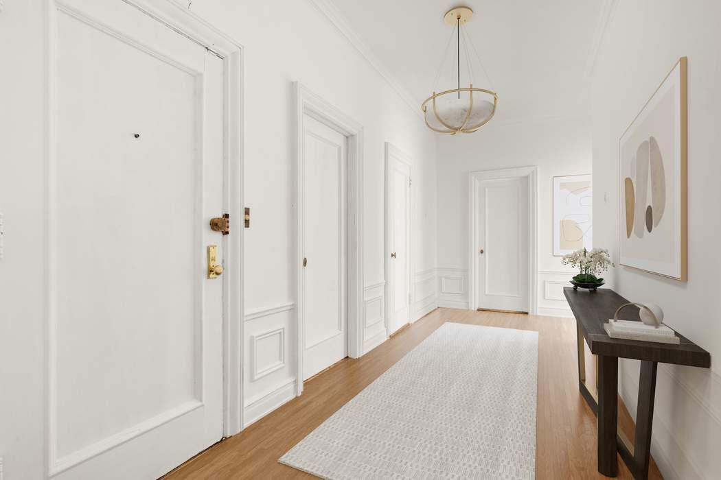 150 East 72nd Street, Unit 6S Manhattan, NY 10021 - Photo 20 of 23 a view of a room with a chandelier fan and wooden floor
