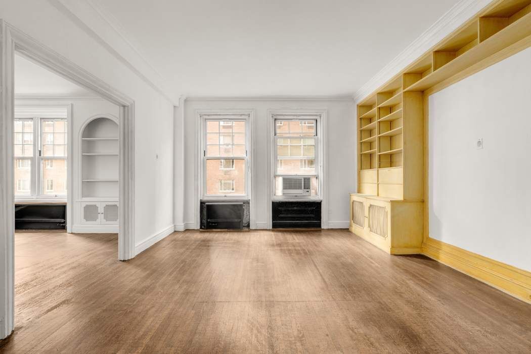 150 East 72nd Street, Unit 6S Manhattan, NY 10021 - Photo 6 of 23 an empty room with windows closet and fireplace