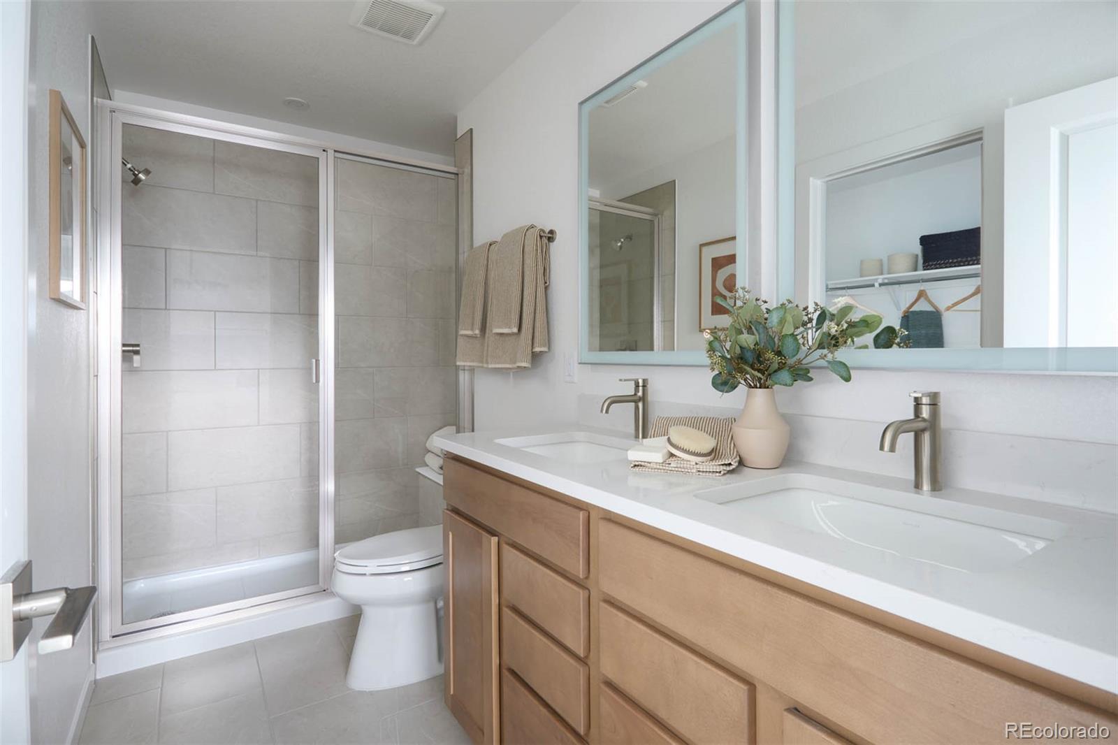 11942 Soprano Trail Lone Tree, CO 80134 - Photo 8 of 11 a bathroom with a granite countertop sink a toilet and shower