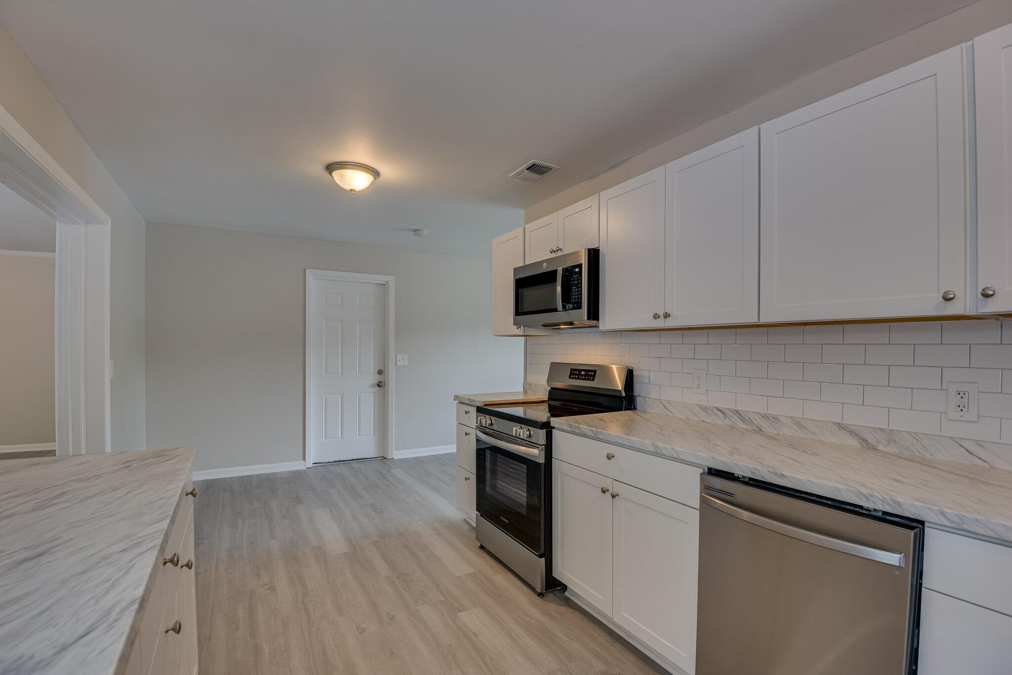 2115 Ashley Drive Augusta, GA 30906 - Photo 15 of 38 a kitchen with granite countertop white cabinets and white appliances