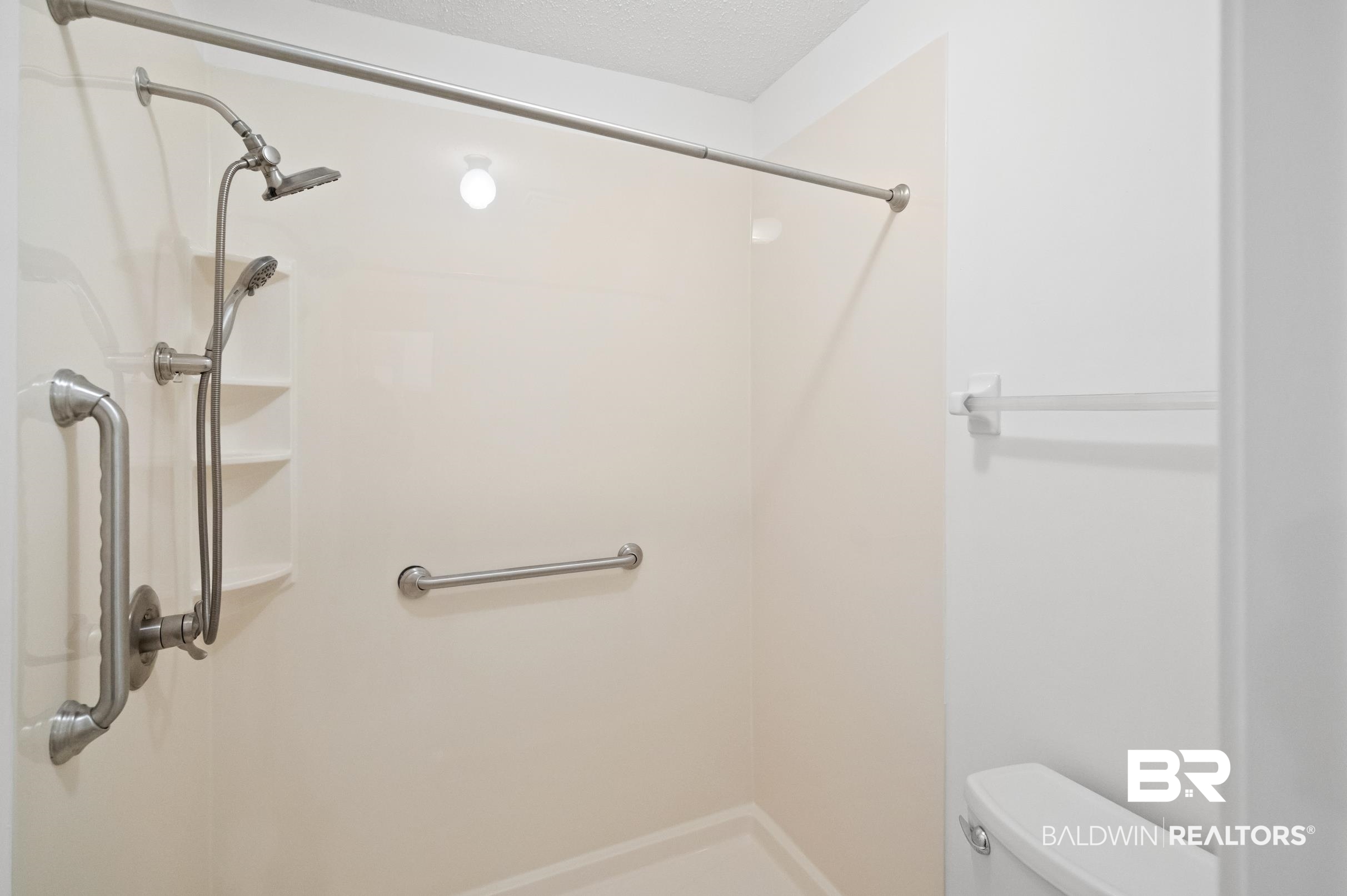 128 Dunbar Loop Daphne, AL 36526 - Photo 17 of 39 Bathroom featuring a shower, toilet, and a textured ceiling