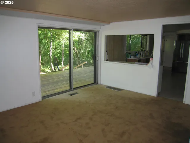 a view of empty room with floor to ceiling window