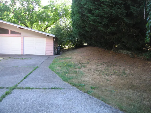 a view of a house with a yard and garage