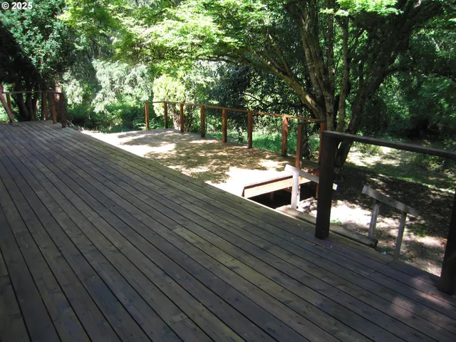 a backyard of a house with lots of green space and trees in the back