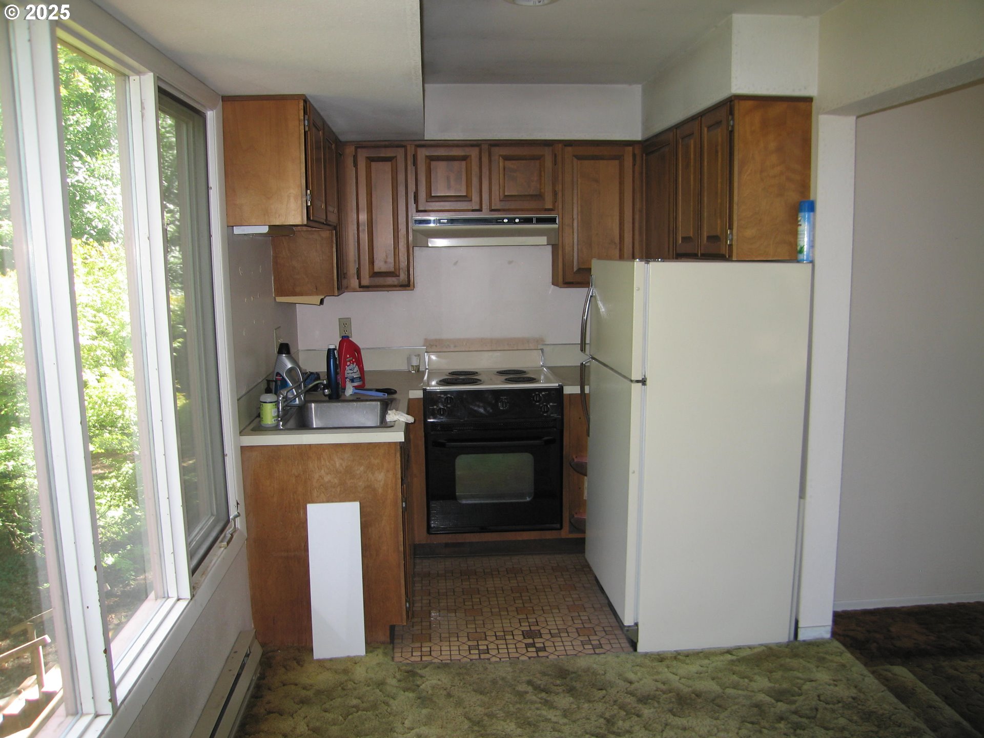 18795 Southwest Vista Street Beaverton, OR 97003 - Photo 5 of 31 a kitchen with granite countertop cabinets stainless steel appliances and a window