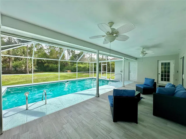 a view of a living room and kitchen with a large window