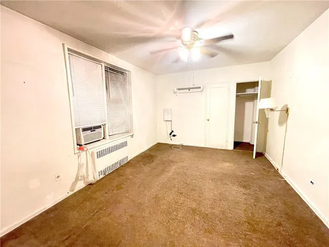 a view of a livingroom with a ceiling fan and window
