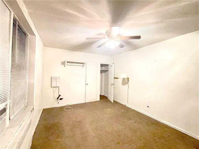 a view of a building with garden and sitting area