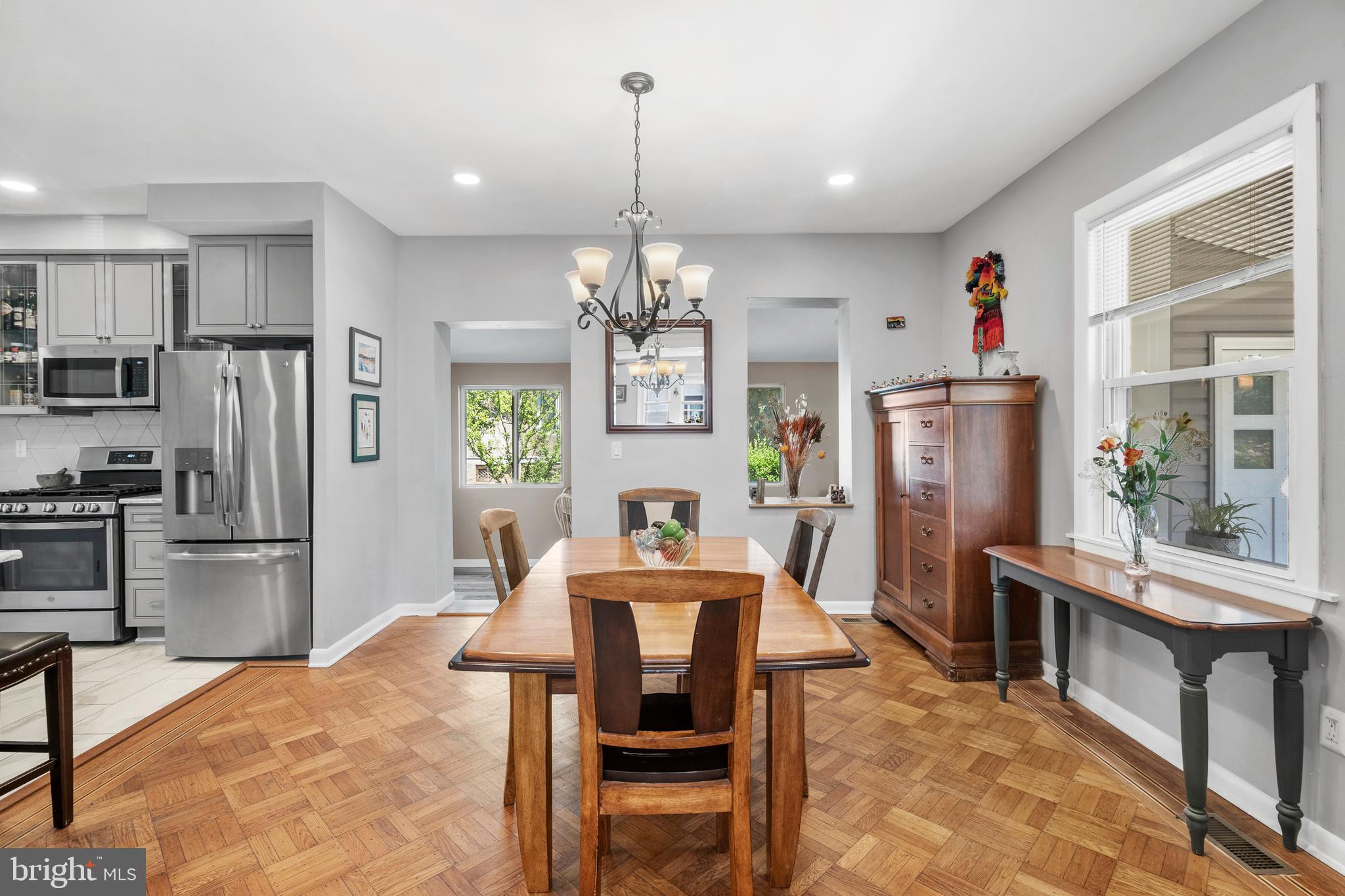 1118 Allston Road Havertown, PA 19083 - Photo 12 of 58 a kitchen with stainless steel appliances kitchen island granite countertop a refrigerator a stove top oven a sink dishwasher and a dining table with wooden floor