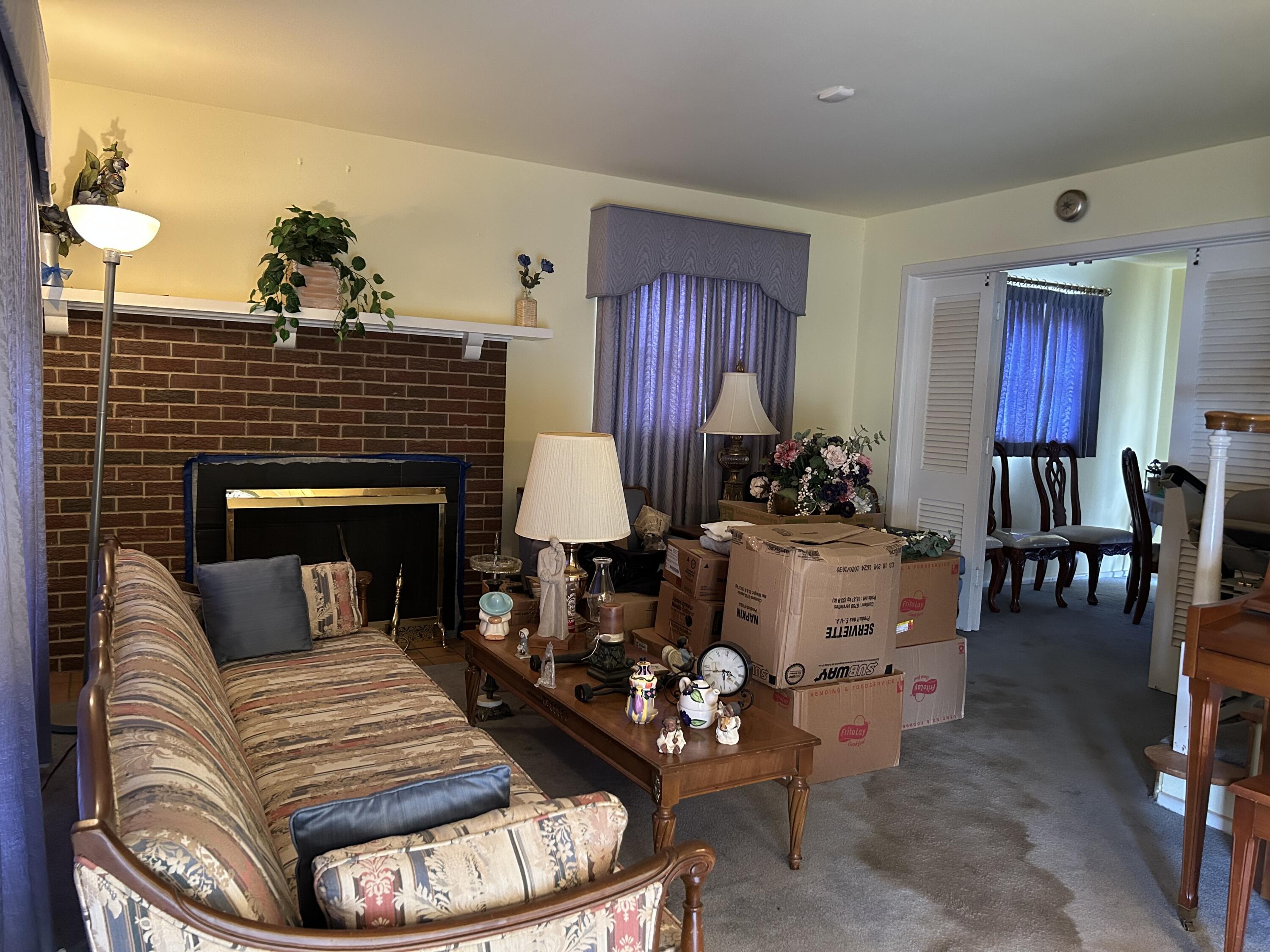2802 Walnut Avenue Lubbock, TX 79404 - Photo 2 of 13 a living room with furniture a fireplace and a flat screen tv