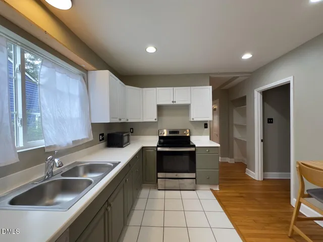 a kitchen with a sink a stove and refrigerator