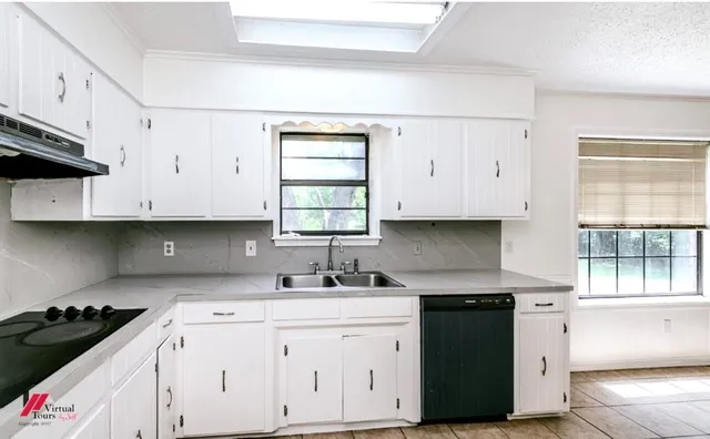 a kitchen with a sink stove and cabinets
