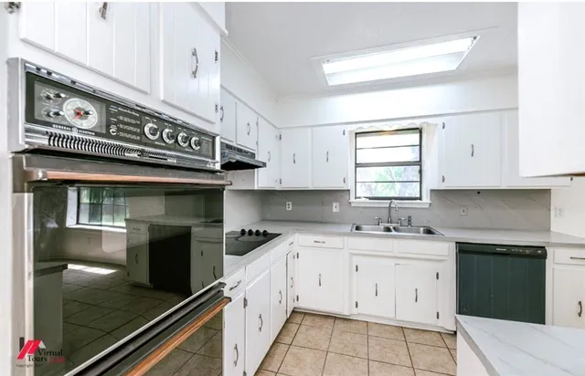 a kitchen with a sink cabinets and window