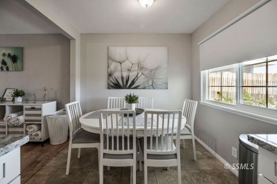 1341 Sims Street Ridgecrest, CA 93555 - Photo 8 of 27 a view of a dining room with furniture a chandelier and wooden floor