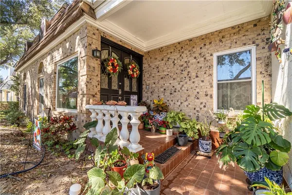 front view of a house with a potted plant