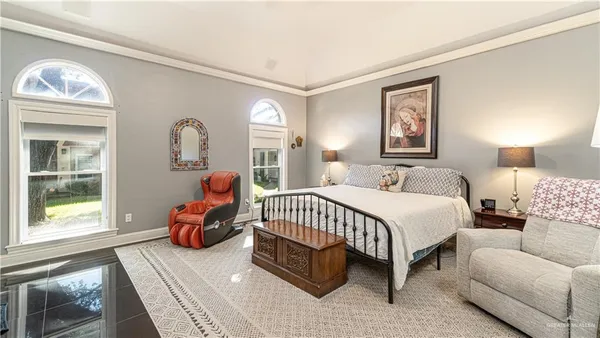 a bedroom with a bed couch and window