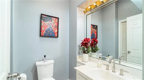 a bathroom with a toilet sink and mirror
